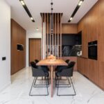 Stylish kitchen with wooden furniture and dining zone